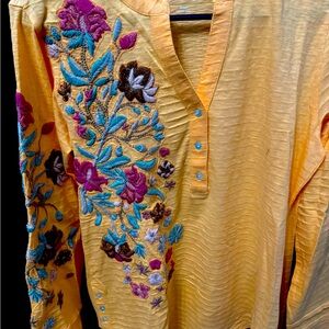 Orange top with embroidery on arm and front